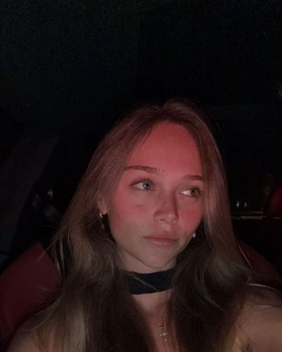 Kyla Dodds radiant smile with a vivid, flowing gown