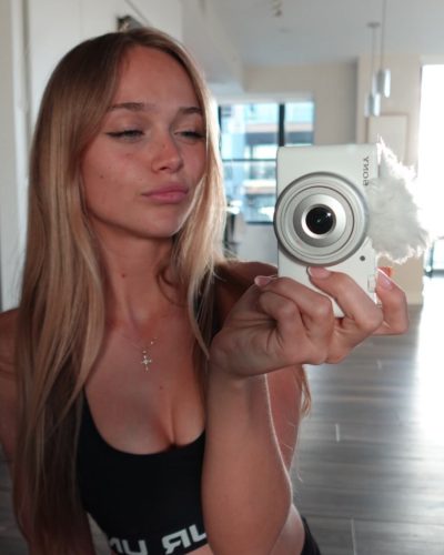 Kyla Dodds in a cozy beige sweater and black leggings.