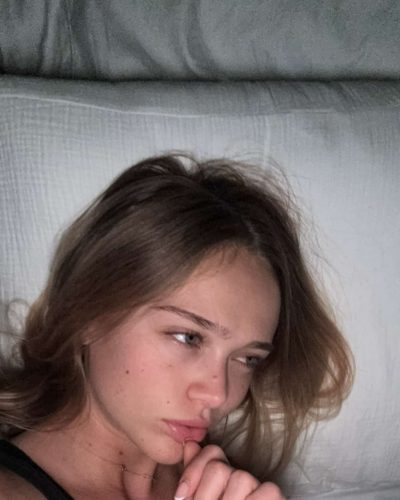 Kyla Dodds in a red sundress with a playful pattern.