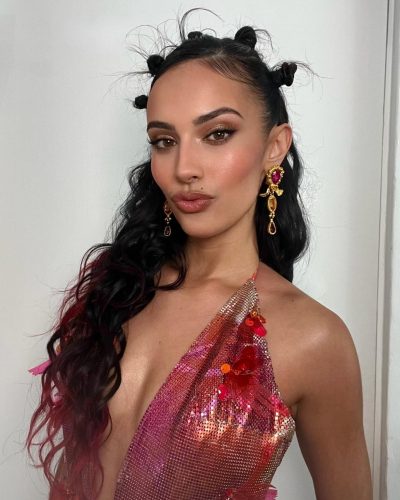 Kylie Cantrall wearing a plunging neckline colorful dress