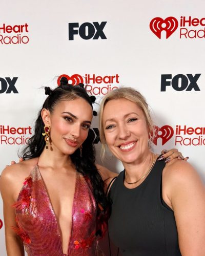 Kylie Cantrall in a vibrant dress featuring a plunging neckline