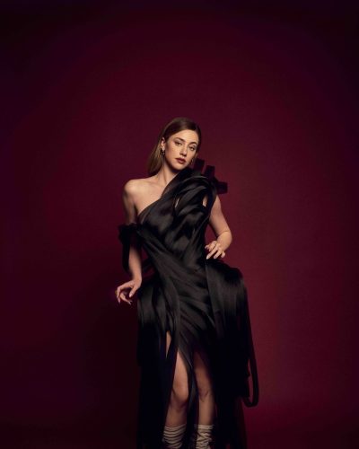 Lili Reinhart floral yellow dress accentuated by soft waves hairstyle