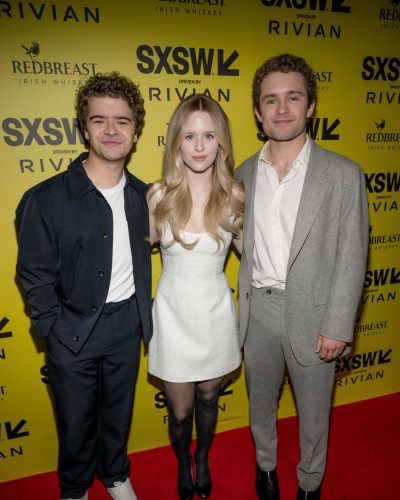 Lulu Wilson in modern white gown with striking black heels