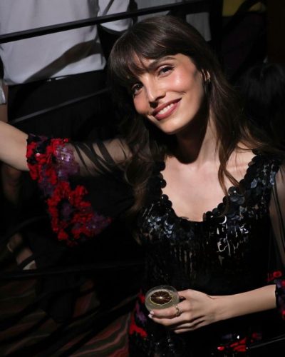 Lux Pascal in a black gown featuring delicate ruffles