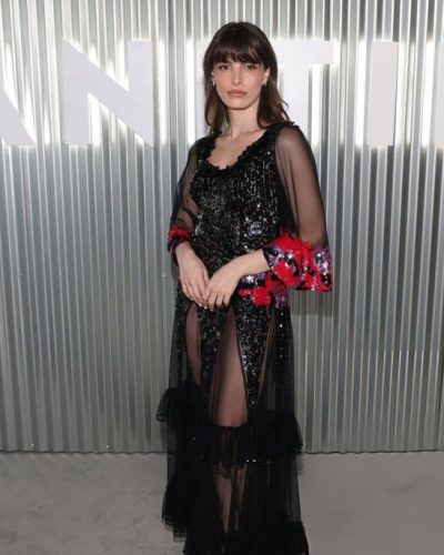 Lux Pascal in a black gown with cascading ruffles and florals