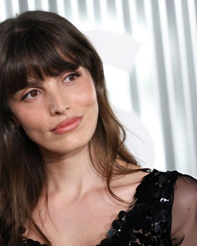 Lux Pascal in black sheer gown with sequins and red florals