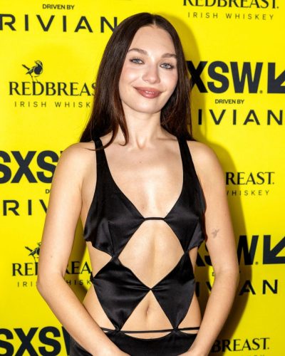 Maddie Ziegler striking black gown paired with elegant heels