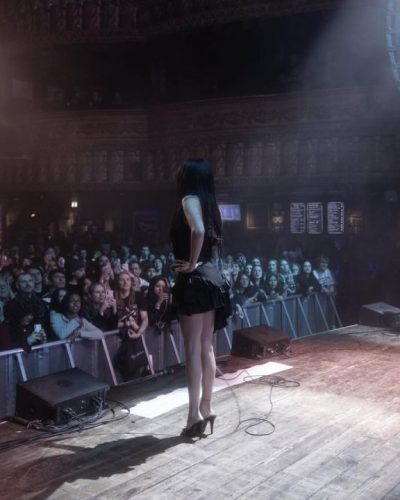 Maggie Lindemann ruffled black dress and high-heeled shoes