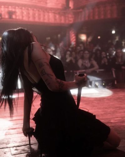 Maggie Lindemann black ruffled dress with sharp heels