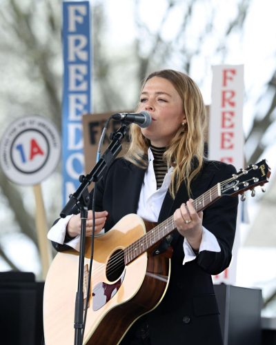 Maggie Rogers in a black-and-white striped turtleneck and blazer.