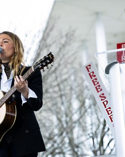 Maggie Rogers dressed in a fitted blazer and casual jeans.