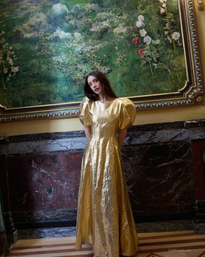 Maria Pedraza layered accessories with mint green top and orange skirt