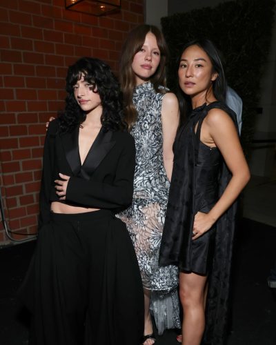 Mia Goth in charming wavy hair with elegant floral gown