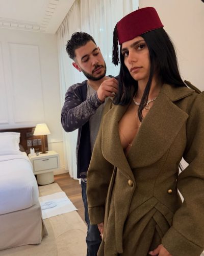 Mia Khalifa in soft, flowing gown with bold accents.