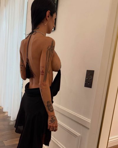 Mia Khalifa in chic oversized jacket with metallic highlights.