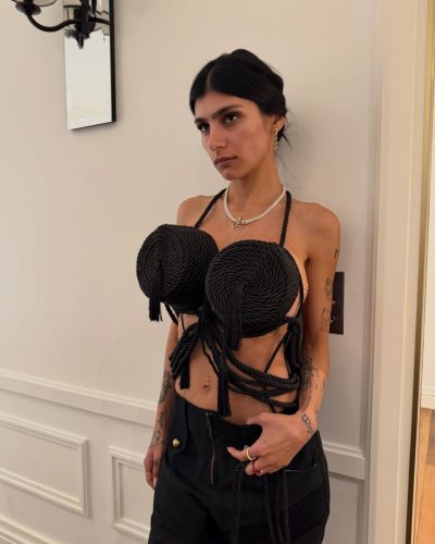 Mia Khalifa in playful metallic dress with flowing fabric.