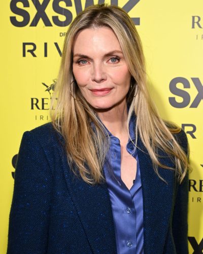 Michelle Pfeiffer in chic navy suit paired with satin blouse