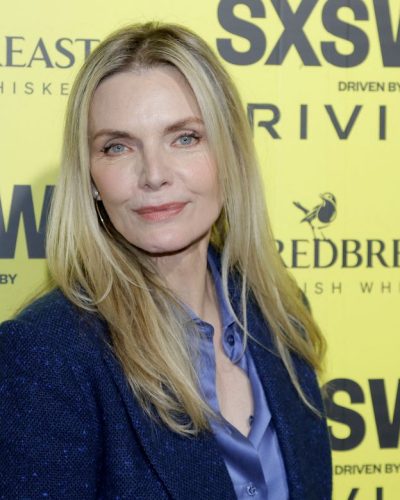 Michelle Pfeiffer wearing textured blazer and flared trousers in gray