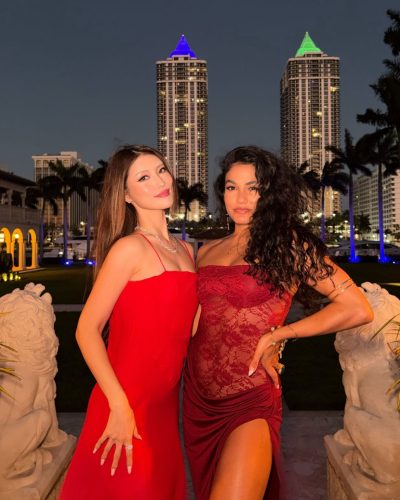 Mika Takeuchi in a fitted blue dress with gold stripes