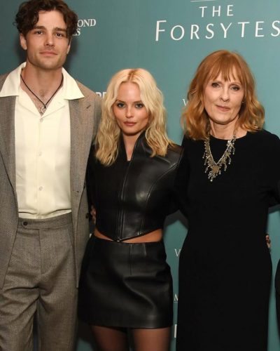 Millie Gibson in a black leather gown with stylish heels