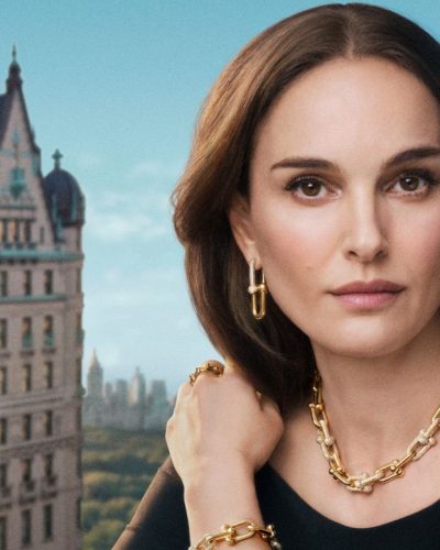 Natalie Portman chic black turtleneck styled with statement earrings.