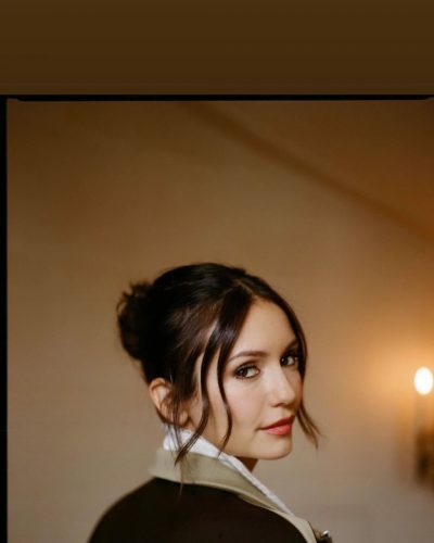 Nina Dobrev burgundy top paired with sleek black mini skirt