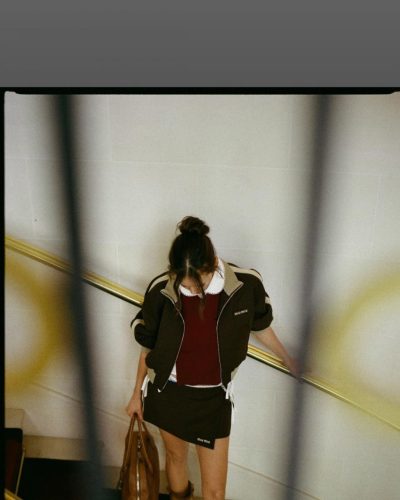 Nina Dobrev soft jacket layered over sleek black mini skirt