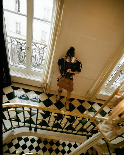 Nina Dobrev stylish color-block jacket over rich burgundy top