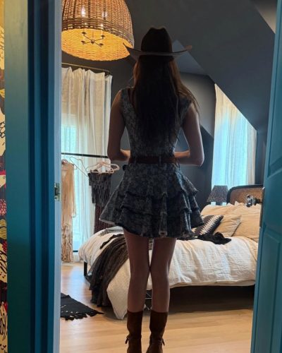 Nina Dobrev in a black dress featuring intricate embroidery