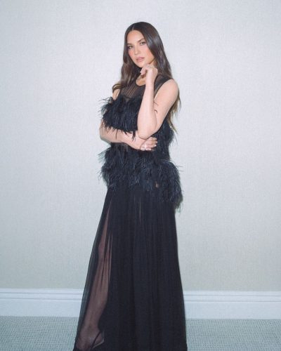 Olivia Munn in a yellow gown with layered design.