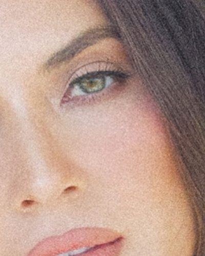 Olivia Munn in a green dress with eye-catching patterns.