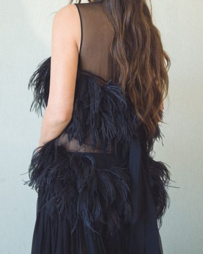 Olivia Munn wearing a black jumpsuit with unique detailing.