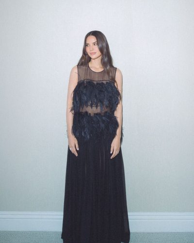 Olivia Munn dressed in a floral print dress with vibrant colors.