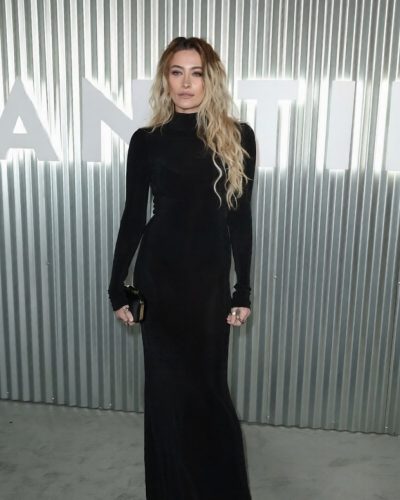 Paris Jackson stylish black dress with soft waves hairstyle