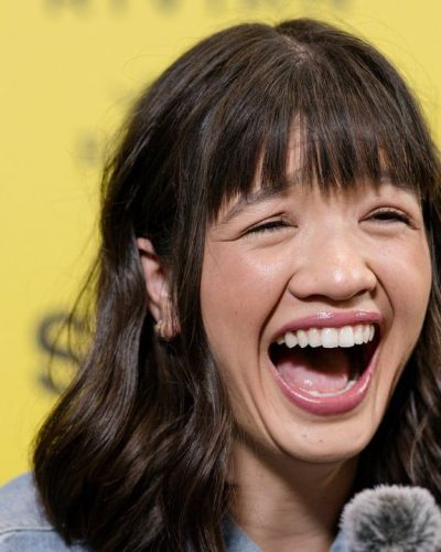 Peyton Elizabeth Lee styled in soft waves and signature bangs