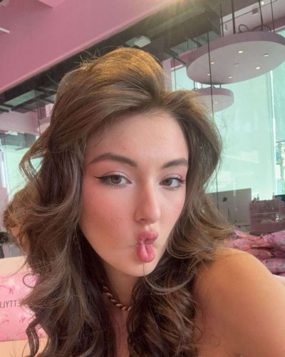 Rachel Pizzolato chic burgundy dress accentuating her figure