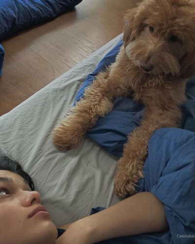 Rachel Zegler in fitted white dress with glimmering detail.