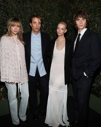 Robert Pattinson wearing dark blazer and relaxed-fit trousers