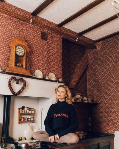 Saoirse-Monica Jackson sleek navy dress complemented by statement jewelry