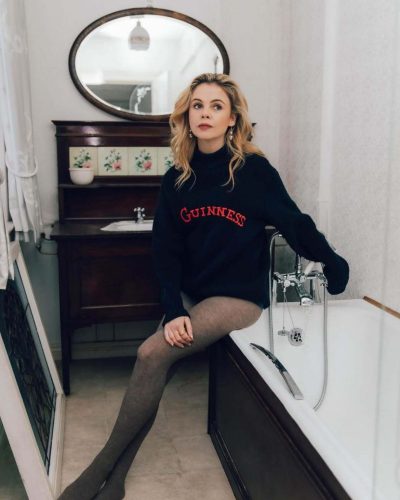 Saoirse-Monica Jackson chic navy gown with statement earrings