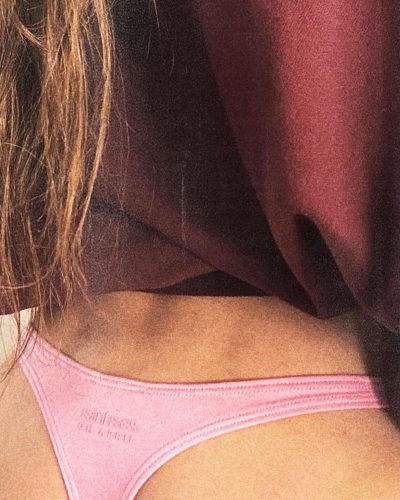Sarah Shahi wearing pink bikini top with cozy maroon sweater
