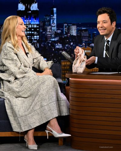 Uma Thurman wearing monochromatic cream outfit with stylish layers