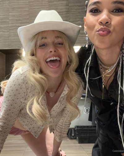 Victoria Pedretti black dress with heart accents and vibrant blue boots