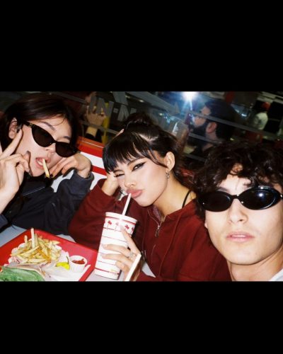 Xochitl Gomez in a black crop top and flowing skirt