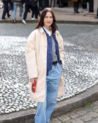 Alexa Chung layered grey sweater and navy shirt under beige coat