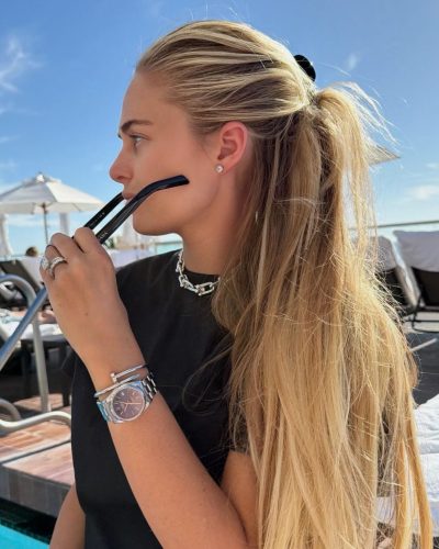 Alexa Serowik relaxed in a black crop top and comfortable sneakers.