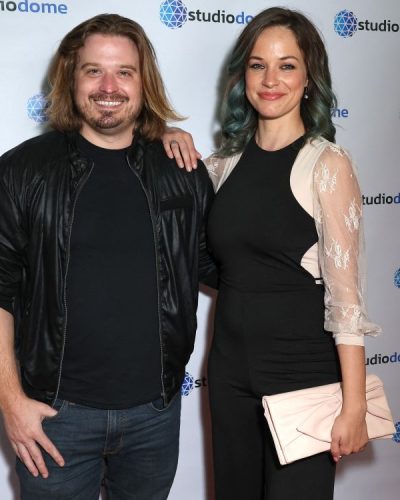 Alexis Knapp modern black jumpsuit with playful sheer sleeves.