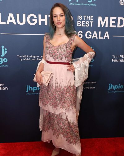 Alexis Knapp in a pastel floral dress and nude sandals