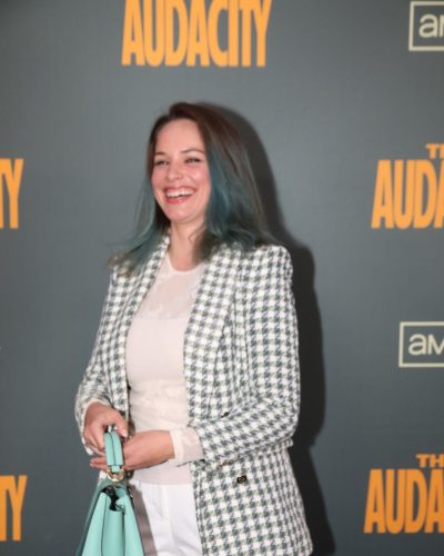 Alexis Knapp peace sign gesture with mint handbag