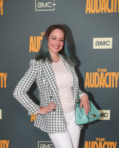 Alexis Knapp white fitted trousers paired with lace top